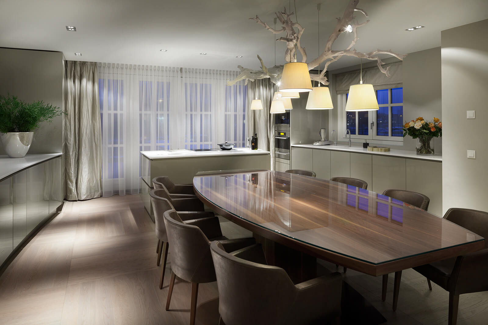 Keuken van Villa SL met grote tafel en aan de achterzijde bij de raampartij een kookeiland