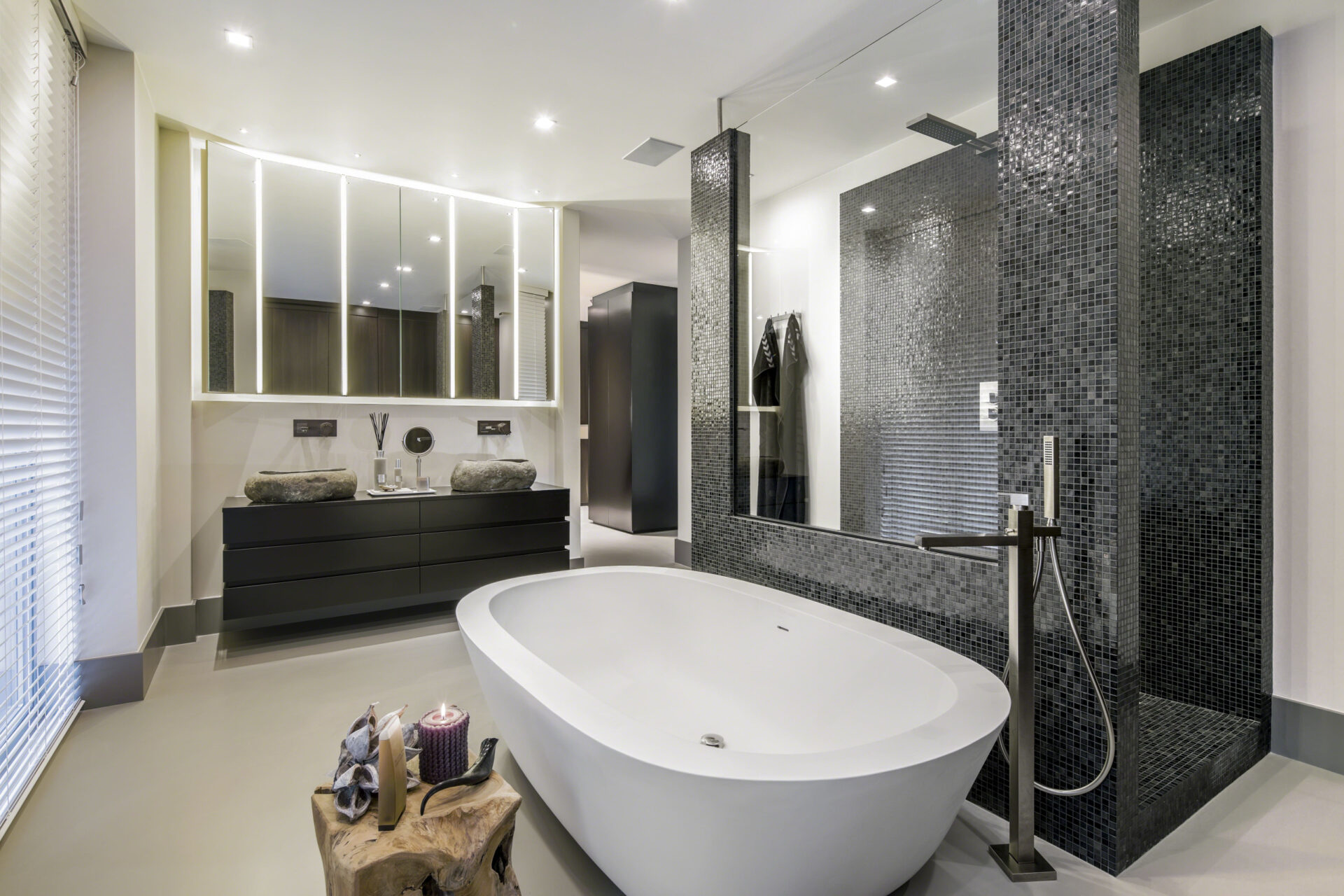 Badkamer met ruime badkuip, douche en wastafels